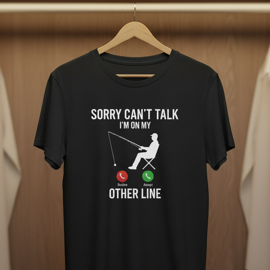 Black t-shirt with a graphic design hanging in a wardrobe with other clothes.