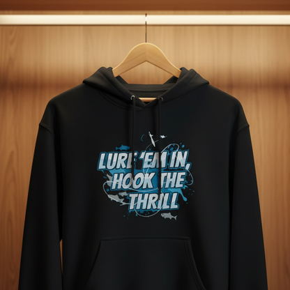Black hoodie with text 'Lure'em in, hook the thrill' hanging in a wooden wardrobe.