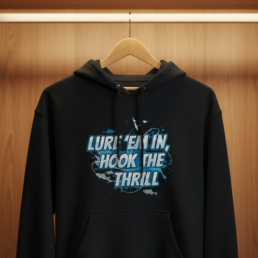 Black hoodie with text 'Lure'em in, hook the thrill' hanging in a wooden wardrobe.